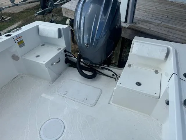 Slide: The Image of 2025 Parker 23SE Center Console boat with outboard motor and seating area. - 10