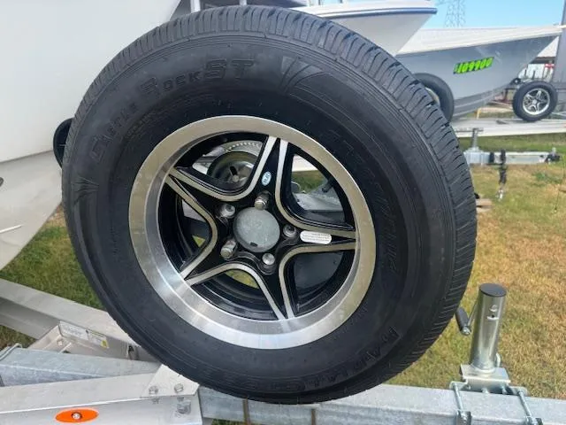 Slide: The Image of Trailer tire for 2025 Parker 23SE Center Console boat on display. - 16