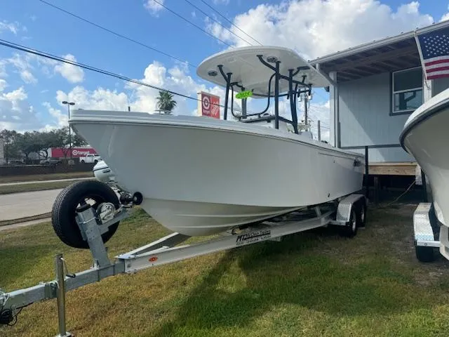 Slide: The Image of 2025 Parker 23SE Center Console boat on trailer, displayed outdoors under a cloudy sky. - 2
