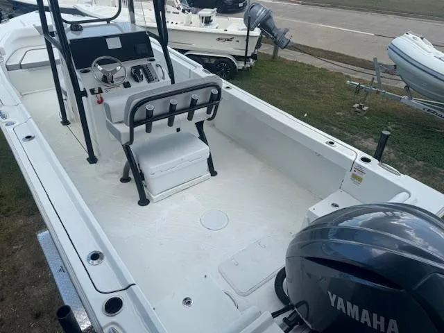 Slide: The Image of 2025 Parker 23SE Center Console boat with Yamaha engine, docked on grass. - 5