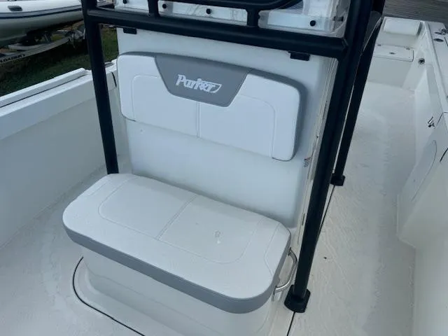 Slide: The Image of 2025 Parker 23SE Center Console boat seating area with white and gray cushions. - 7