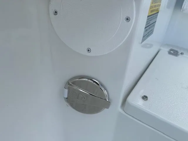 Slide: The Image of 2025 Parker 23SE Center Console boat detail, featuring a chrome fuel cap. - 8