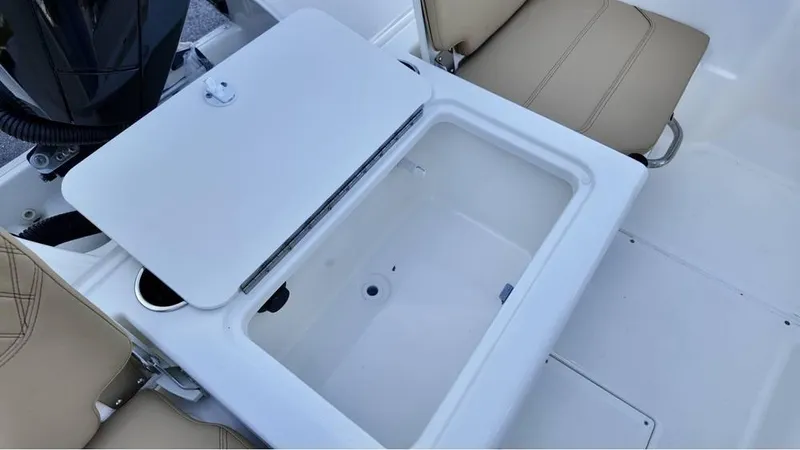 Slide: The Image of 2025 Bayliner Trophy 22 CC boat interior with open storage compartment. - 10