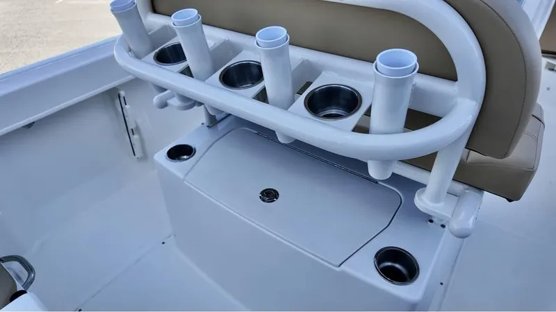 Slide: The Image of 2025 Bayliner Trophy 22 CC boat interior with rod holders and cup holders. - 11