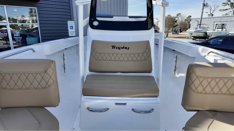 Slide: The Image of 2025 Bayliner Trophy 22 CC boat interior with beige seating and modern design. - 14