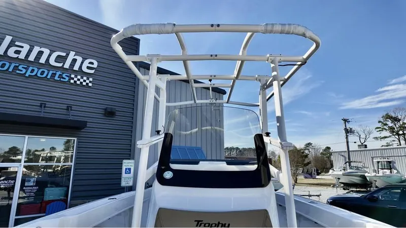 Slide: The Image of 2025 Bayliner Trophy 22 CC boat at dealership, showcasing T-top and console. - 15