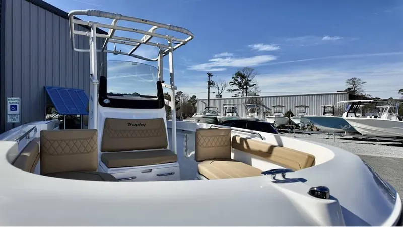 Slide: The Image of 2025 Bayliner Trophy 22 CC boat with seating, docked outdoors under clear sky. - 4