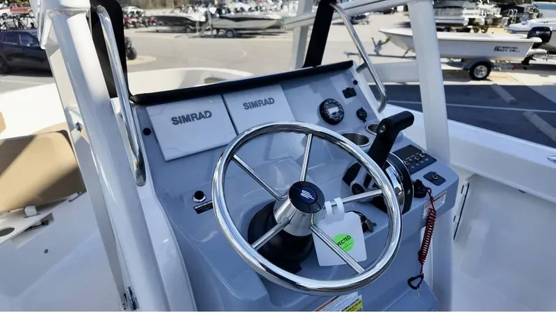 Slide: The Image of 2025 Bayliner Trophy 22 CC boat dashboard with steering wheel and Simrad electronics. - 7