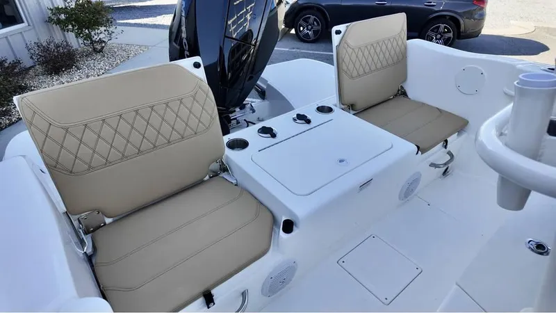 Slide: The Image of 2025 Bayliner Trophy 22 CC boat interior with beige cushioned seats and center console. - 9