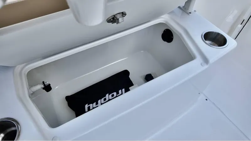 Slide: The Image of 2025 Bayliner Trophy 22 CC storage compartment with cup holders. - 12