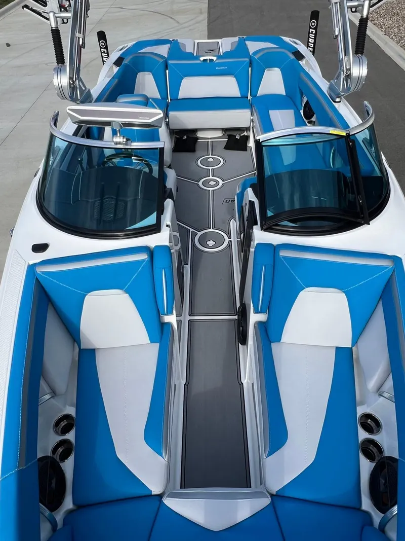 Slide: The Image of 2018 MasterCraft XStar boat with blue and white interior, sleek design, and modern features. - 12