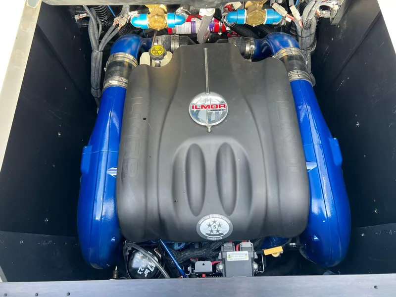 Slide: The Image of 2018 MasterCraft XStar Ilmor engine with blue accents in boat compartment. - 13
