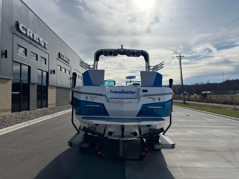 Slide: The Image of 2018 MasterCraft XStar boat parked outside dealership under cloudy sky. - 5
