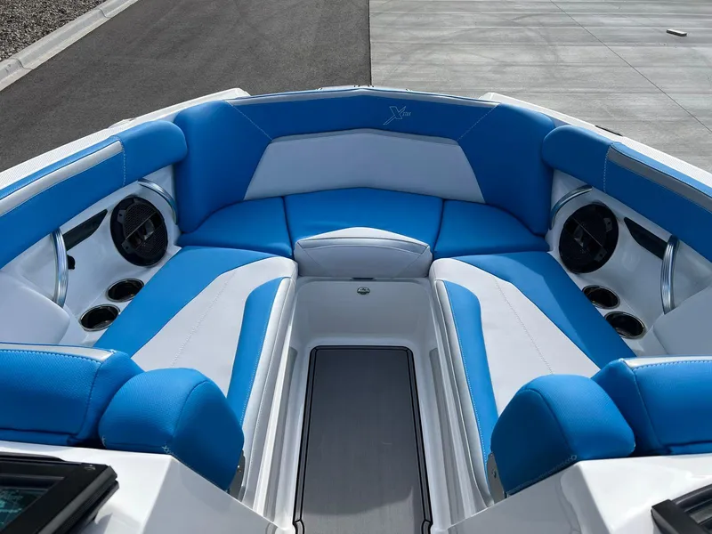 Slide: The Image of 2018 MasterCraft XStar boat interior with blue and white seating. - 8