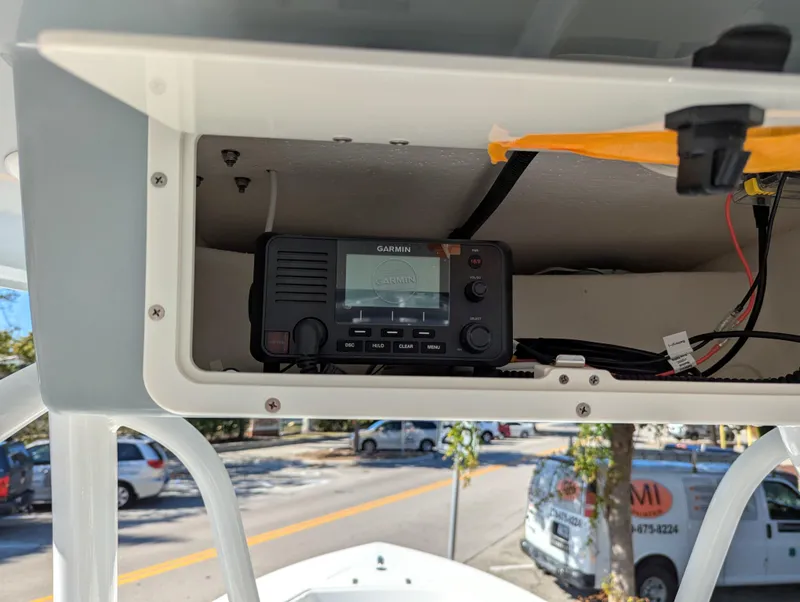 Slide: The Image of 2025 BlackJack 256 Coastal boat with Garmin radio installed in overhead compartment. - 13