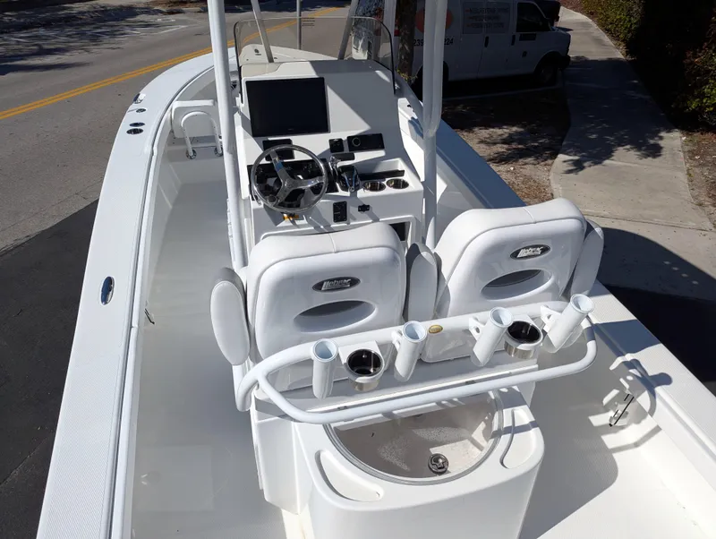 Slide: The Image of 2025 BlackJack 256 Coastal boat interior with dual seats and steering console. - 14