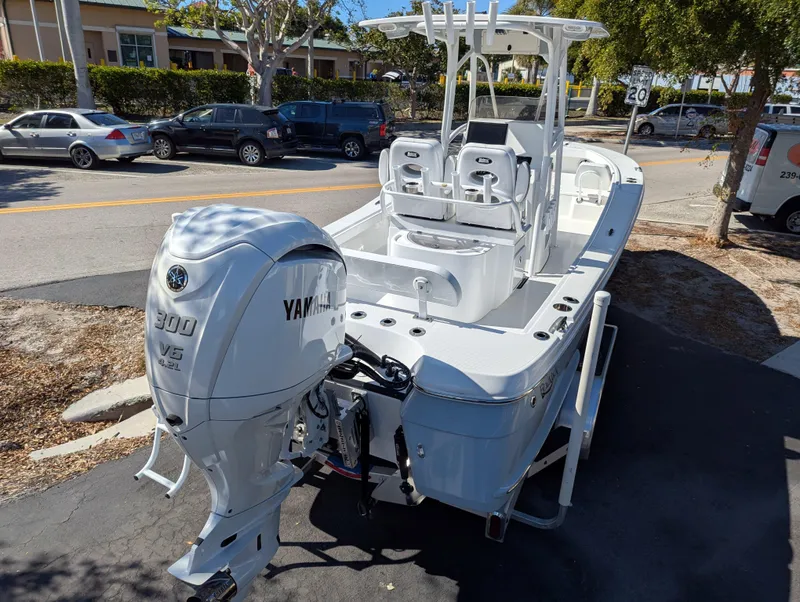 Slide: The Image of 2025 BlackJack 256 Coastal boat with Yamaha 300 V6 engine, parked on street. - 4