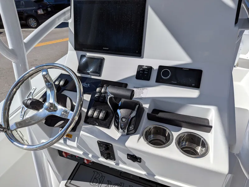Slide: The Image of BlackJack 256 Coastal 2025 boat dashboard with steering wheel and controls. - 5