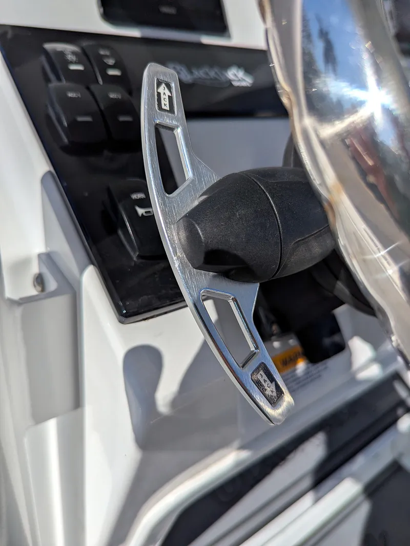 Slide: The Image of Close-up of 2025 BlackJack 256 Coastal boat steering wheel and controls. - 6