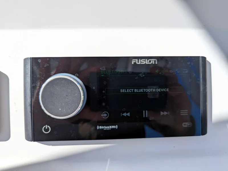 Slide: The Image of Fusion stereo system on BlackJack 256 Coastal 2025 boat, displaying "Select Bluetooth Device." - 7