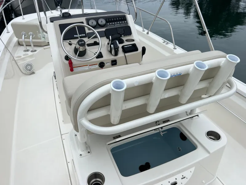 Slide: The Image of 2022 Boston Whaler 210 Montauk boat interior with steering console and rod holders. - 3