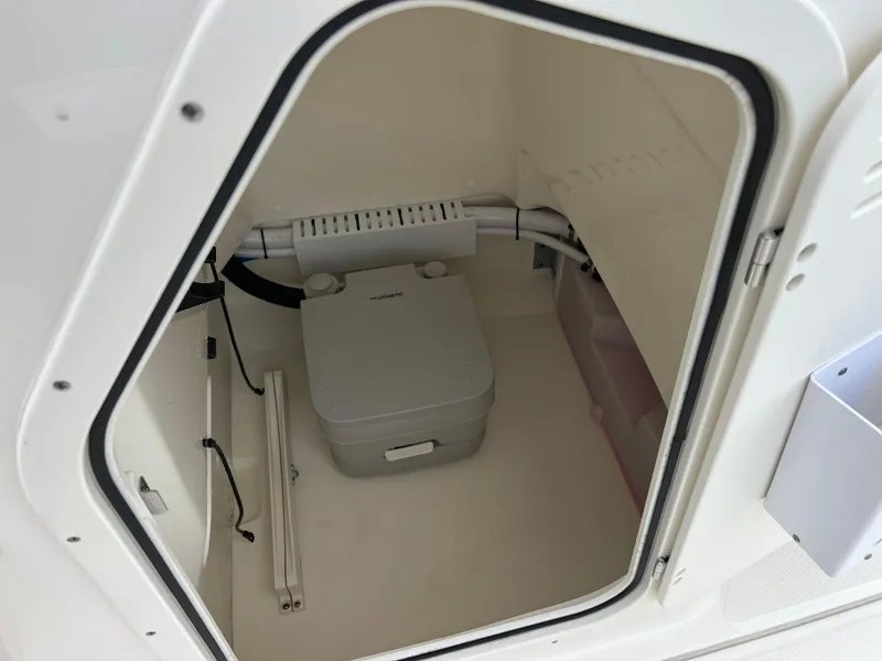 Slide: The Image of 2022 Boston Whaler 210 Montauk boat storage compartment with portable toilet. - 5