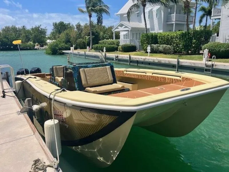Slide: The Image of 2025 BlueCat boat docked on turquoise water, featuring fiberglass and carbon fiber design. - 10