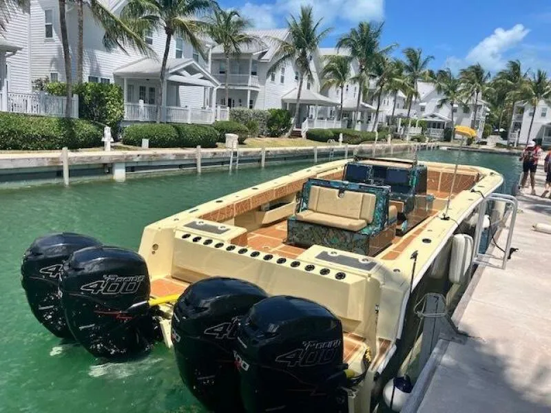 Slide: The Image of BlueCat 2025 boat with triple engines docked in a tropical canal setting. - 11