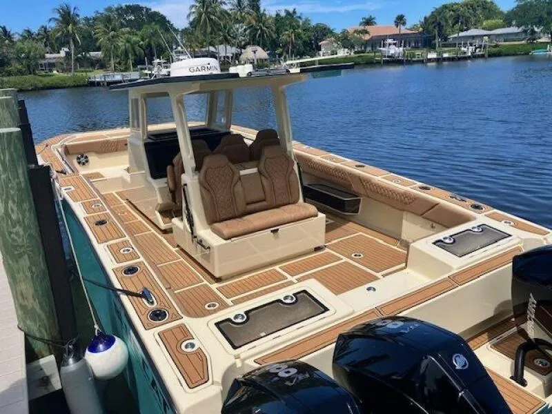 Slide: The Image of 2025 BlueCat boat with fiberglass and carbon fiber deck, docked by a serene lake. - 6