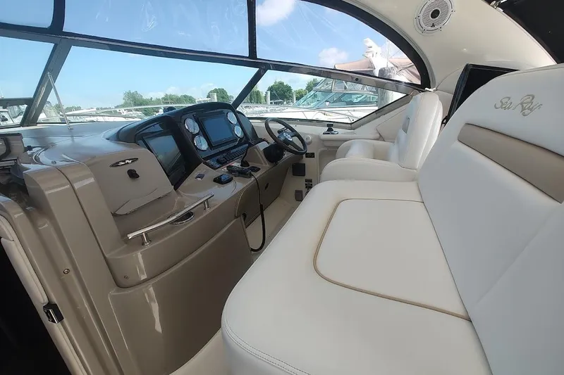 Slide: The Image of Interior of 2009 Sea Ray 380 Sundancer yacht with modern dashboard and plush seating. - 13