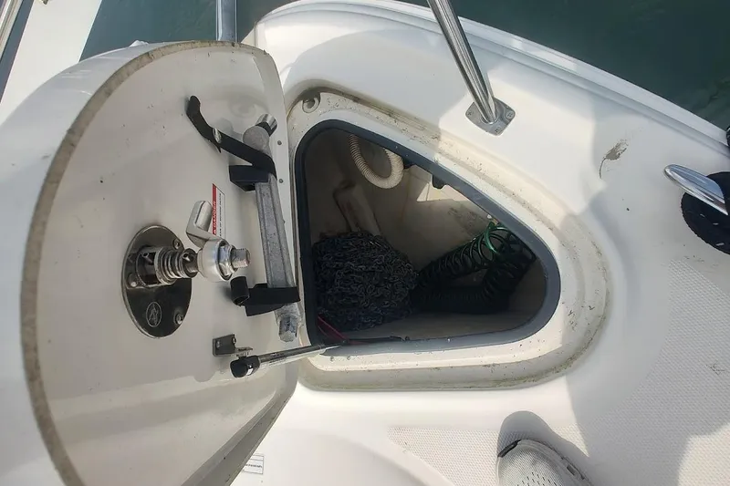 Slide: The Image of Open anchor locker on a 2009 Sea Ray 380 Sundancer boat, showing chain and hose. - 20