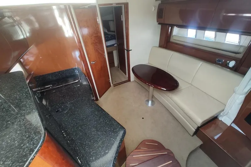 Slide: The Image of Interior of 2009 Sea Ray 380 Sundancer yacht with elegant seating and kitchenette. - 21