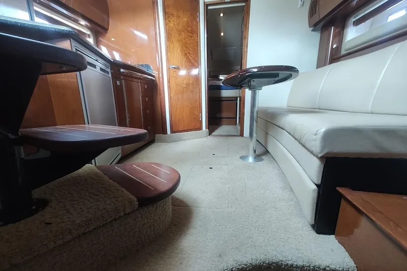 Slide: The Image of Interior of 2009 Sea Ray 380 Sundancer yacht with modern furnishings and wooden cabinetry. - 29