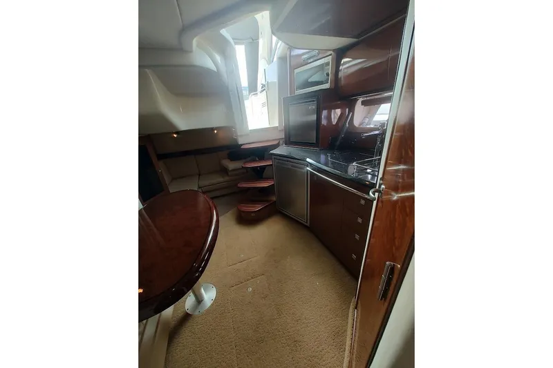 Slide: The Image of Luxurious interior of 2009 Sea Ray 380 Sundancer yacht with kitchen and seating area. - 31