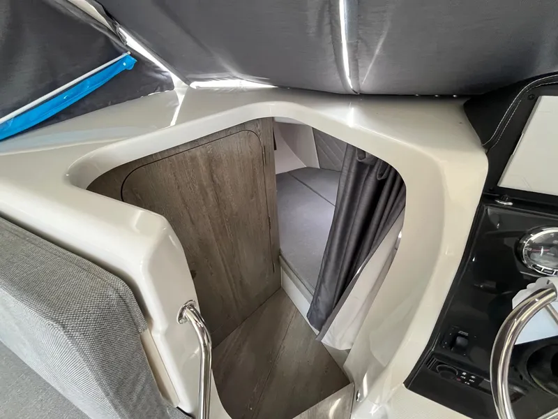 Slide: The Image of Interior cabin view of 2025 Bayliner Trophy T25 Explorer boat, featuring modern design and cozy sleeping area. - 15