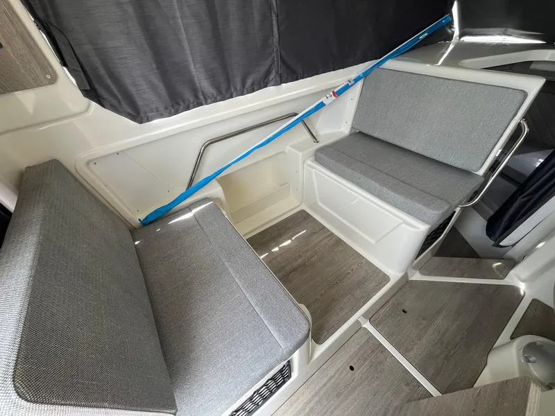 Slide: The Image of Interior seating of 2025 Bayliner Trophy T25 Explorer boat with gray cushions. - 20