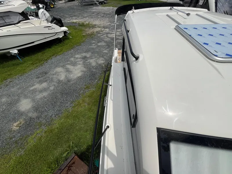 Slide: The Image of 2025 Bayliner Trophy T25 Explorer boat on display at a marina. - 24