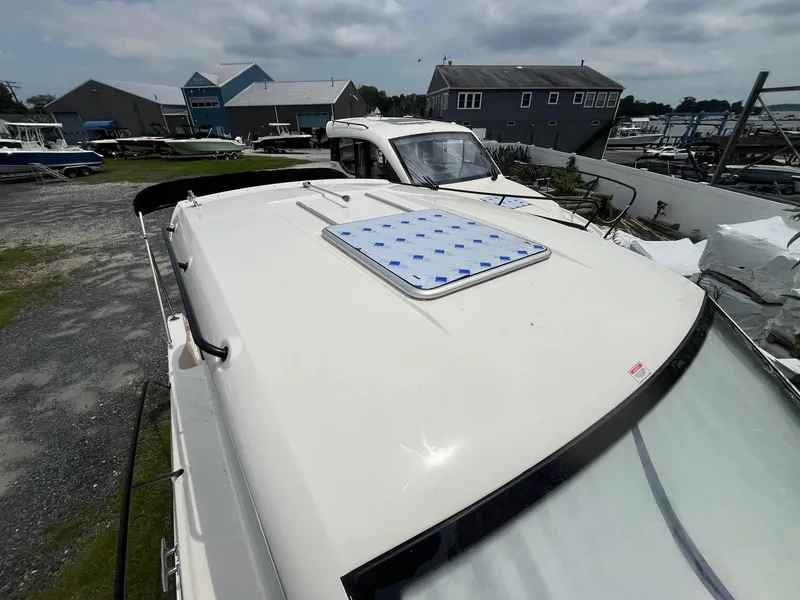 Slide: The Image of 2025 Bayliner Trophy T25 Explorer boat on display at a marina. - 25