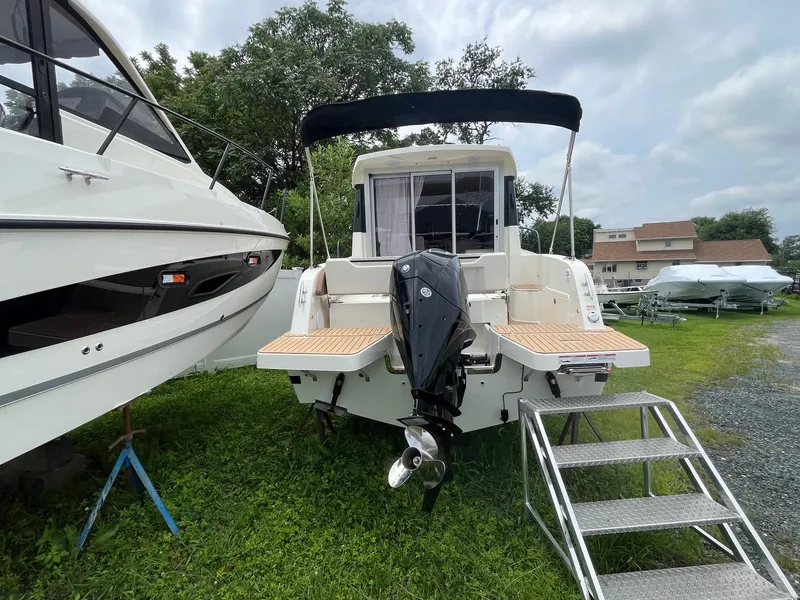 Slide: The Image of 2025 Bayliner Trophy T25 Explorer boat with outboard motor and boarding steps. - 3