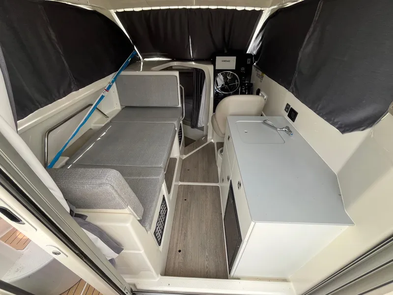 Slide: The Image of Interior of 2025 Bayliner Trophy T25 Explorer boat with seating and kitchenette. - 9