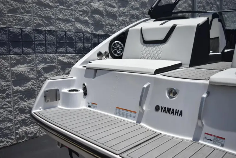 Slide: The Image of 2024 Yamaha Boats 222SD, sleek white deck with seating and speaker. - 10