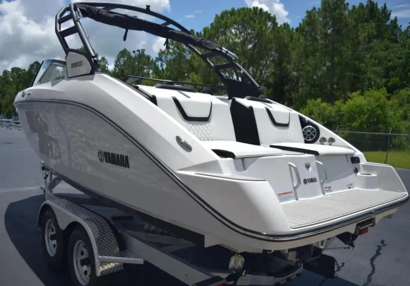 Slide: The Image of 2024 Yamaha Boats 222SD on trailer, sleek design, outdoor setting. - 12