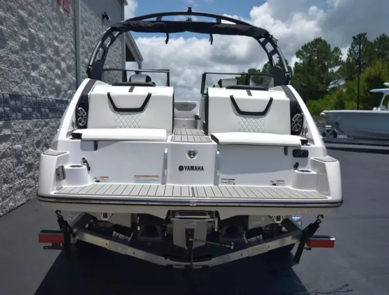 Slide: The Image of 2024 Yamaha Boats 222SD, rear view, sleek design, docked outdoors. - 13