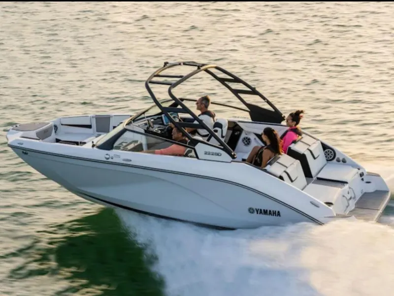 Slide: The Image of 2024 Yamaha Boats 222SD cruising on water with passengers enjoying the ride. - 14