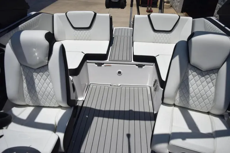 Slide: The Image of 2024 Yamaha Boats 222SD interior with white quilted seating and gray flooring. - 8