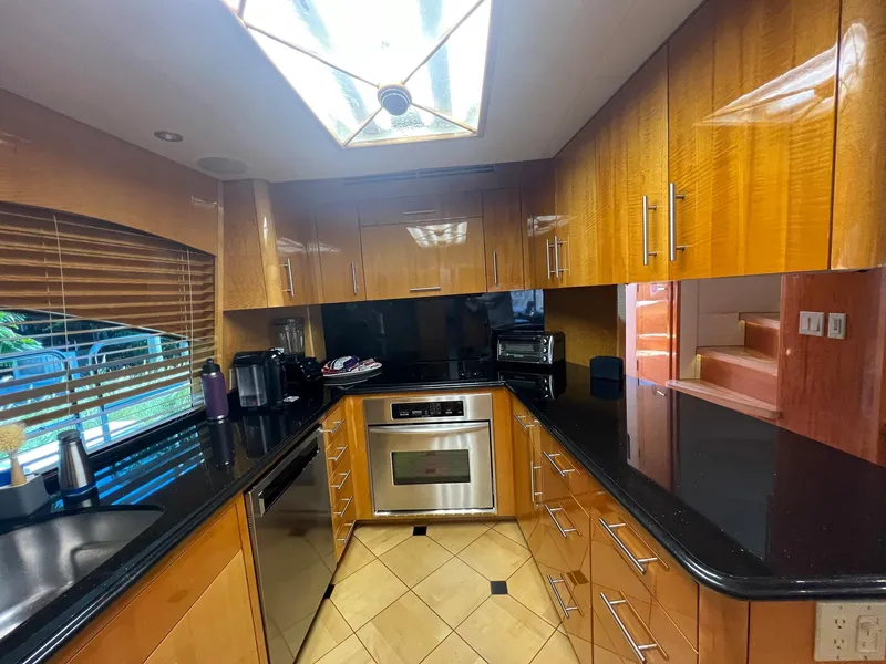 Slide: The Image of Luxurious kitchen in 2004 Hatteras 80 Motor Yacht with wood cabinets and modern appliances. - 13