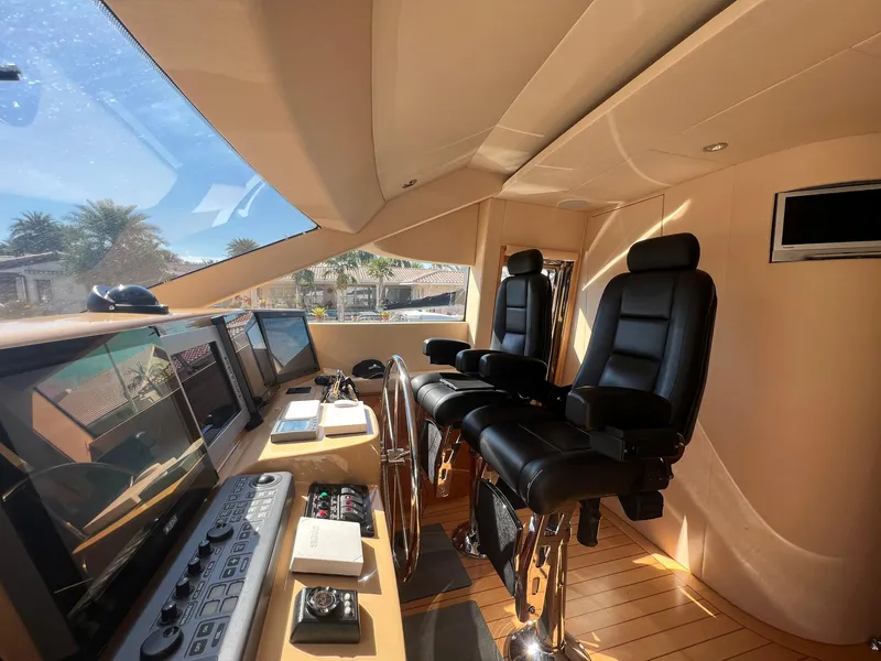 Slide: The Image of Interior helm of 2004 Hatteras 80 Motor Yacht with leather seats and navigation equipment. - 19