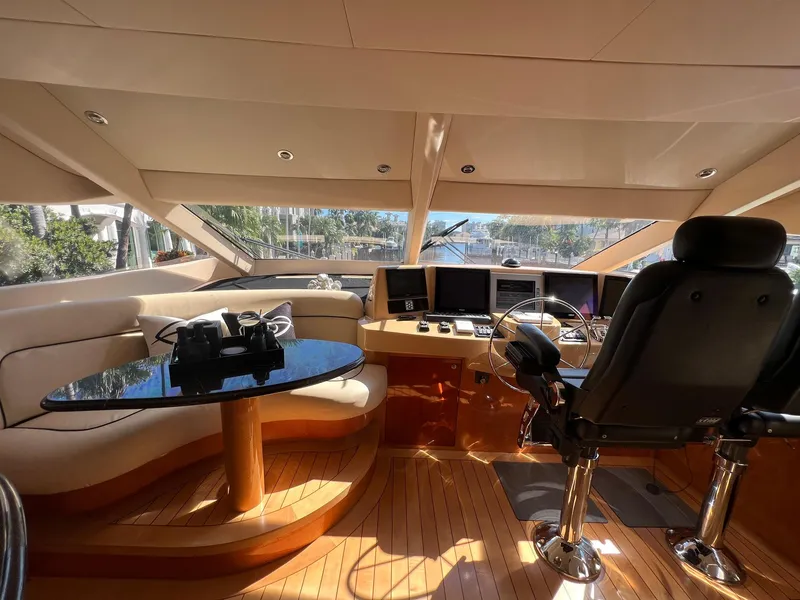 Slide: The Image of Luxurious 2004 Hatteras 80 Motor Yacht helm with plush seating and modern controls. - 20