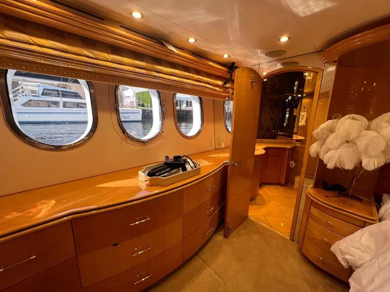 Slide: The Image of Luxurious 2004 Hatteras 80 Motor Yacht interior with elegant wood finishes and porthole windows. - 24