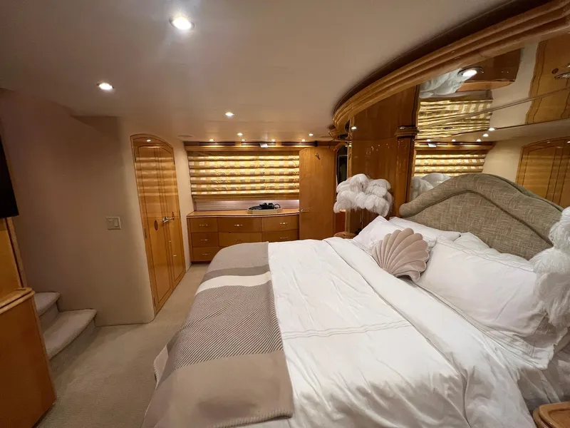 Slide: The Image of Luxurious bedroom in 2004 Hatteras 80 Motor Yacht with elegant wood finishes and plush bedding. - 25